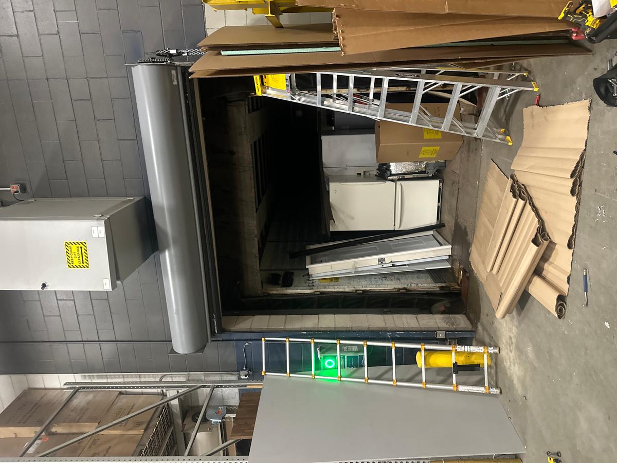 Commercial loading-bay door opening with staging materials — MA service call
