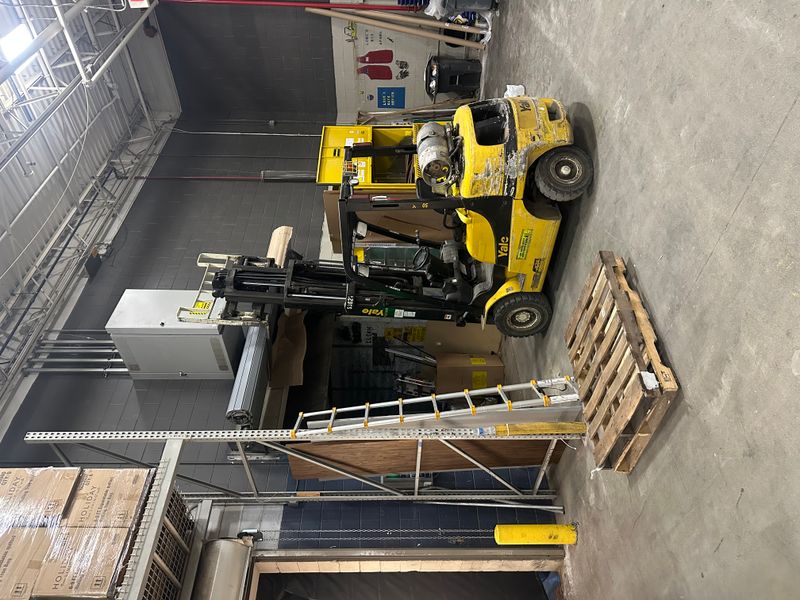 Commercial warehouse with Yale forklift and equipment during door project — MA